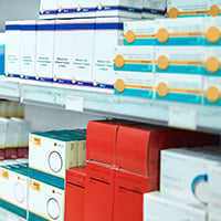 Photograph of a pharmacy's shelves stocked with prescriptions and drugs