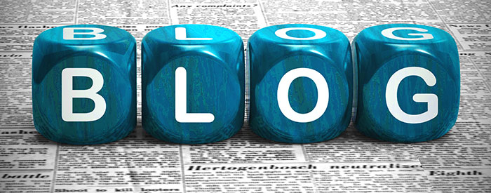 Blog with building blocks spelled out on top of newsprint