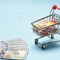 Photograph of hundred dollar bills and a shopping cart full of prescription drugs